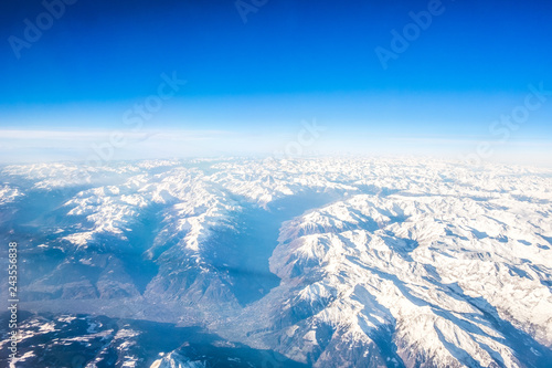 Snow Covered Alps Mountains Aerial view, Clear Blue Sky