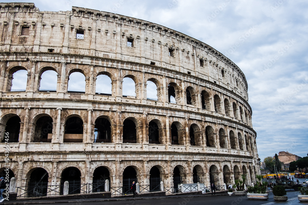 Coliseum or Flavian Amphitheatre or Colosseum (Amphitheatrum Flavium or Colosseo), Rome, Italy. Cloudy blue sky