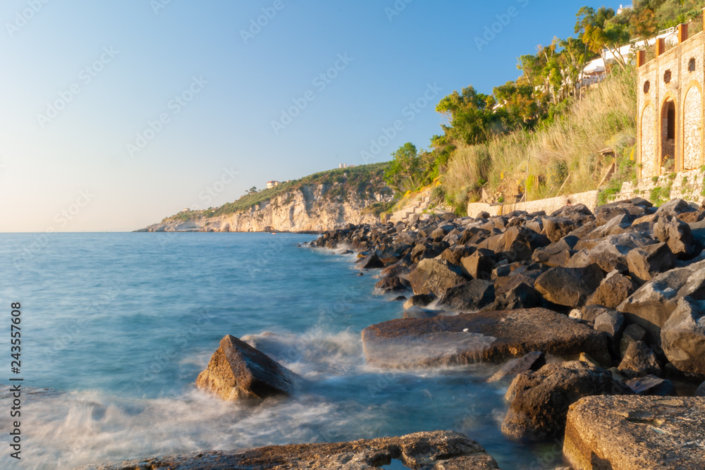 Wonderful shot of the breakwaters of the waterfront of the Marina Lobra of Massa Lubrense, near Sorrento, taken with long time to blur the waves