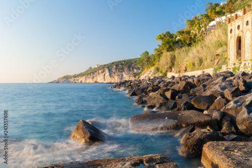 Wonderful shot of the breakwaters of the waterfront of the Marina Lobra of Massa Lubrense, near Sorrento, taken with long time to blur the waves photo