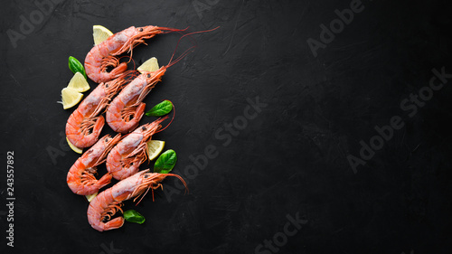 Large shrimp with lemon. Top view. Free space for your text. On the old background.