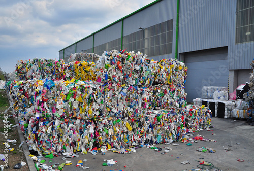 Waste plastic bottles compressed into piles for recycling