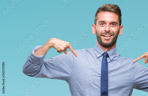 Young handsome business man over isolated background looking confident with smile on face, pointing oneself with fingers proud and happy.