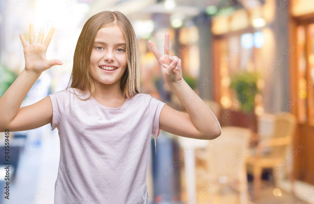 Young beautiful girl over isolated background showing and pointing up with fingers number seven while smiling confident and happy.