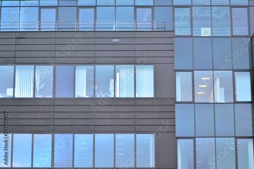 Modern building with reflected sky and cloud in glass window