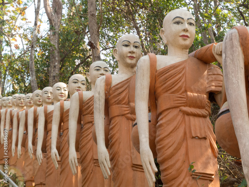 Canvas Print Phnom Sombok, many orange statues in single file, Kratie.