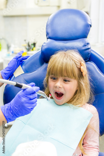 Little girl sitts in the dentist's office