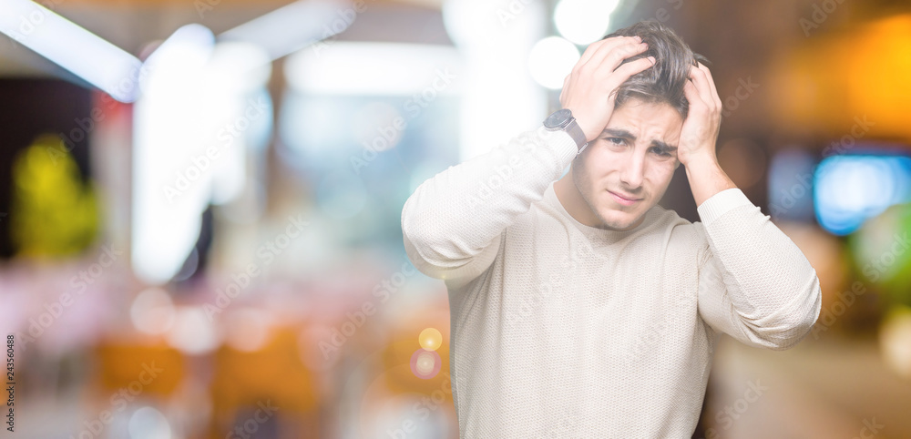 Young handsome man over isolated background suffering from headache desperate and stressed because pain and migraine. Hands on head. Young handsome man over isolated background suffering from headache desperate and stressed because pain and migraine. Hands on head.