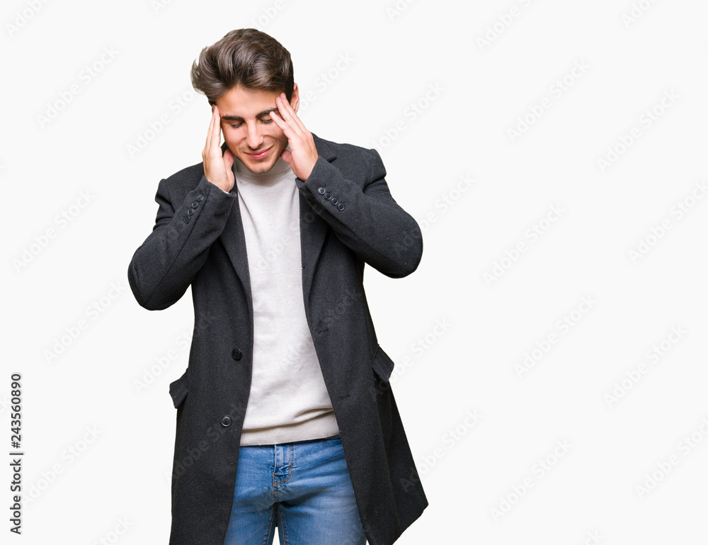 Young elegant man wearing winter coat over isolated background with hand on head for pain in head because stress. Suffering migraine. Young elegant man wearing winter coat over isolated background with hand on head for pain in head because stress. Suffering migraine.
