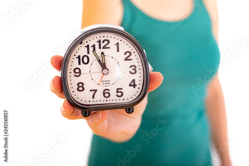 Obraz na płótnie Woman is holding alarm clock