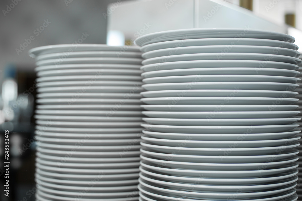 stack of clean white plates in a restaurant. Event prepare details. stack of clean white plates in a restaurant. Event prepare details.