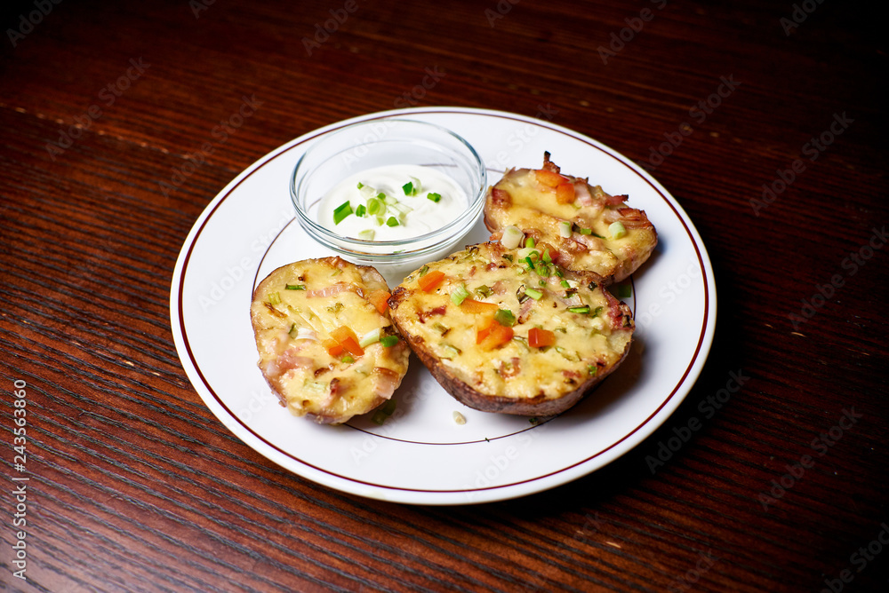 Appetizing dish on a white plate stands on a wooden table, food, snack Appetizing dish on a white plate stands on a wooden table, food, snack