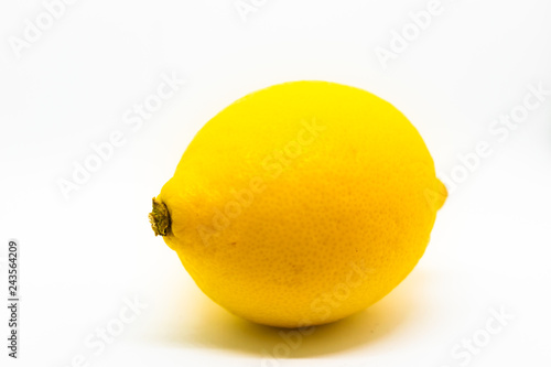 A vibrant yellow whole lemon isolated on white background with blank space for text