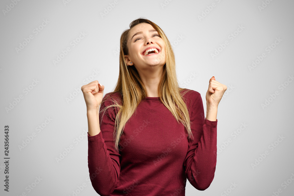 Happy woman winner clenching her fists and yelling Yes with excitement, celebrating, achieving goals. Success, victory, achievement, life and career Happy woman winner clenching her fists and yelling Yes with excitement, celebrating, achieving goals. Success, victory, achievement, life and career