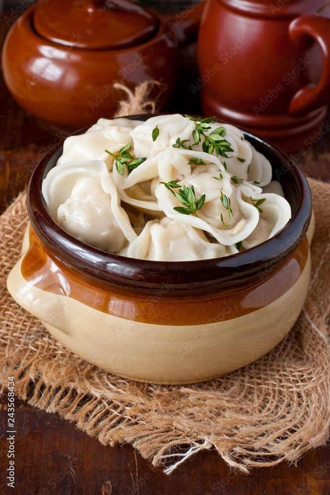 Boiled prepared homemade russian dumplings or pelmeni with beef meat on ceramic  plate