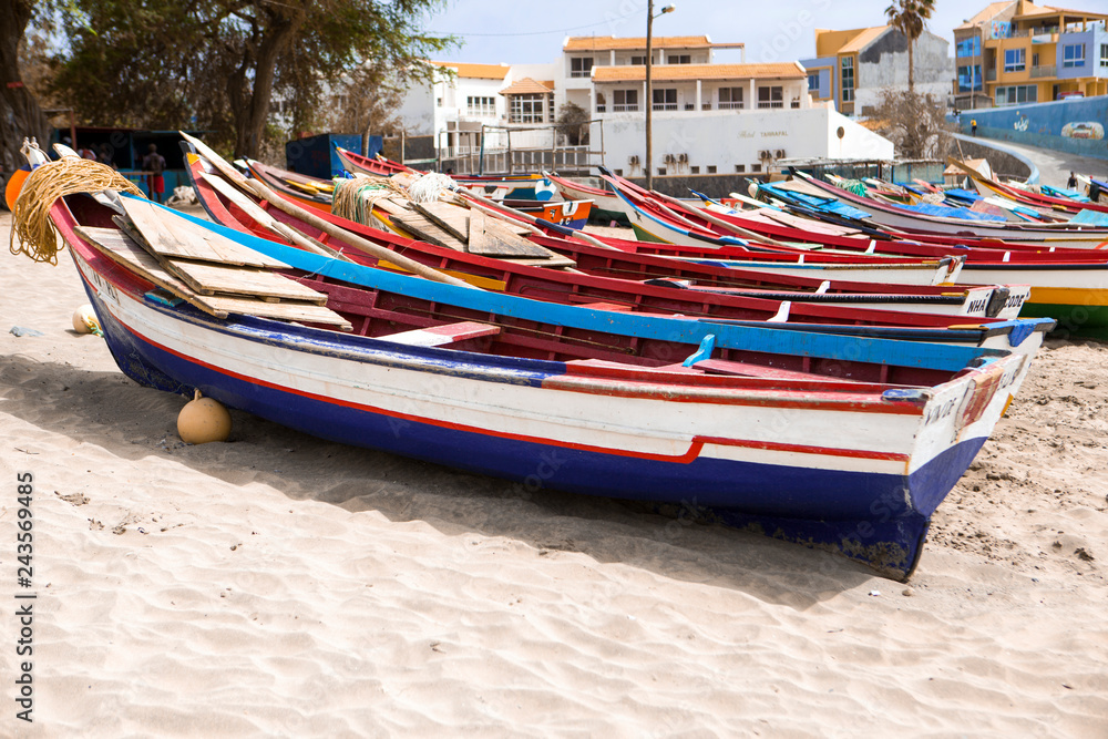 Old fishing pubes on the beach. Colorful boats on the beach of Cape Verde. Old fishing pubes on the beach. Colorful boats on the beach of Cape Verde.