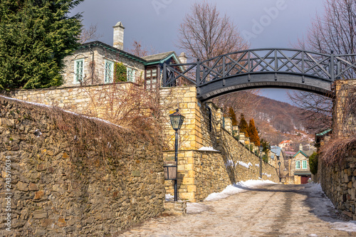 View of traditional stone buildings and streets with snow at the famous village of Nymfaio near Florina, Greece.  photo