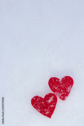 red hearts are powdered with fluffy snow