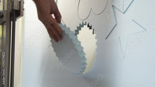 Hot wire CNC foam cutting machine, man removing polystyrene shapes photo