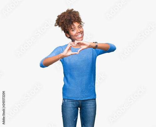 Beautiful young african american woman over isolated background smiling in love showing heart symbol and shape with hands. Romantic concept. © Krakenimages.com