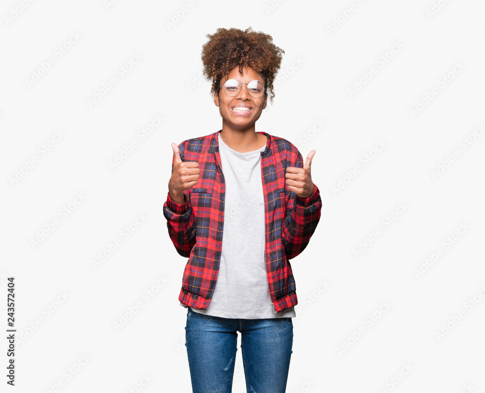 Beautiful young african american woman wearing glasses over isolated background success sign doing positive gesture with hand, thumbs up smiling and happy. Looking at the camera Beautiful young african american woman wearing glasses over isolated background success sign doing positive gesture with hand, thumbs up smiling and happy. Looking at the camera