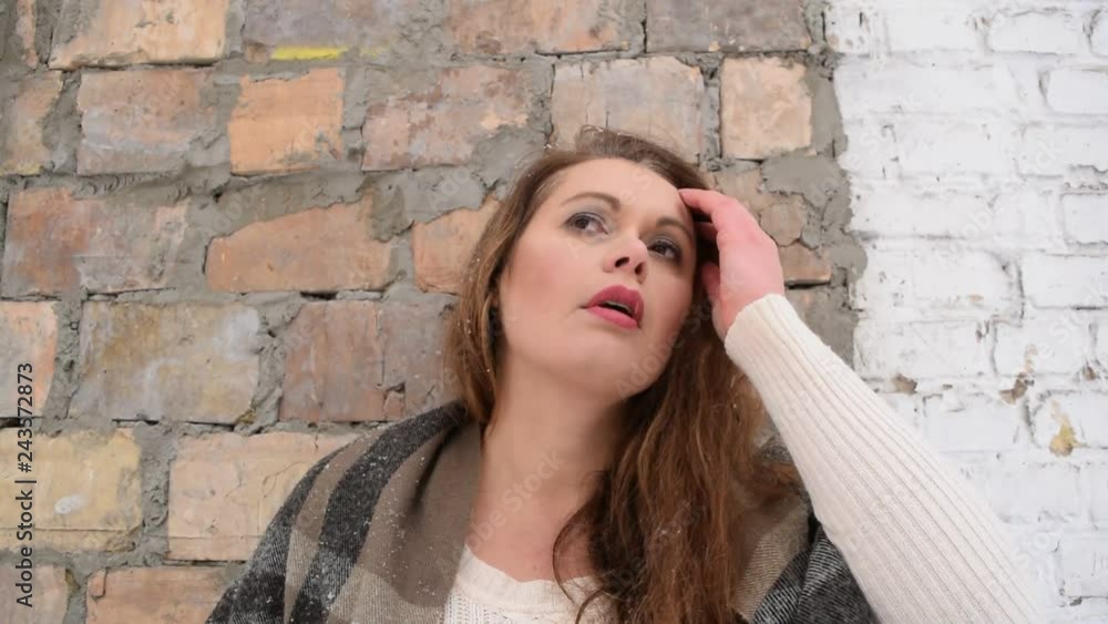 Beautiful fat woman with different emotions on the background of an old brick wall. Beautiful fat woman with different emotions on the background of an old brick wall.