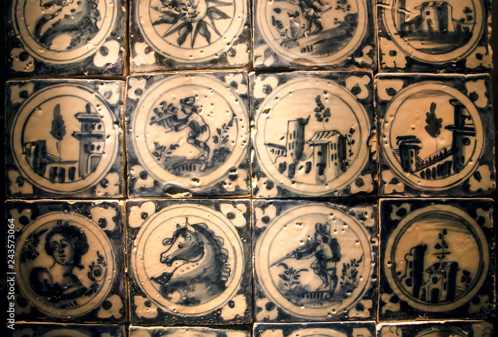 Patterned blue and white ceramic tiles with traditional pictures of life , made in 18th century