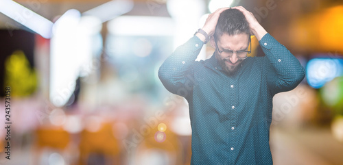 Fotografie Young handsome business man wearing glasses over isolated background suffering from headache desperate and stressed because pain and migraine
