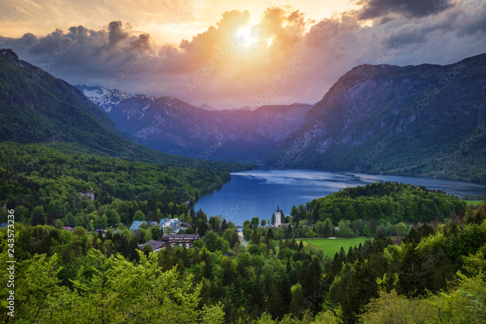 Aerial view of Bohinj lake in Julian Alps. Breathtaking view of the famous Bohinj lake from above. Beautiful view of the Triglav national park and the church of St John the Baptist. Slovenia, Europe Aerial view of Bohinj lake in Julian Alps. Breathtaking view of the famous Bohinj lake from above. Beautiful view of the Triglav national park and the church of St John the Baptist. Slovenia, Europe