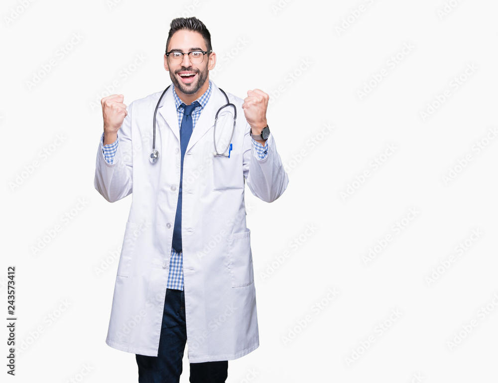 Handsome young doctor man over isolated background celebrating surprised and amazed for success with arms raised and open eyes. Winner concept. Handsome young doctor man over isolated background celebrating surprised and amazed for success with arms raised and open eyes. Winner concept.