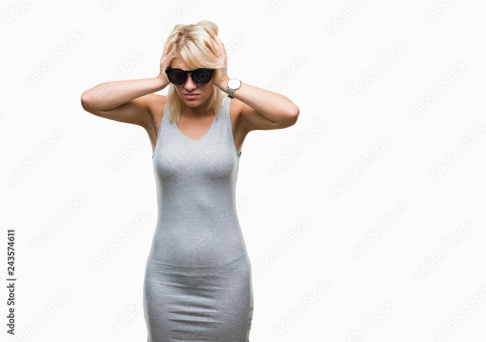Young beautiful blonde woman wearing sunglasses over isolated background suffering from headache desperate and stressed because pain and migraine. Hands on head. Young beautiful blonde woman wearing sunglasses over isolated background suffering from headache desperate and stressed because pain and migraine. Hands on head.