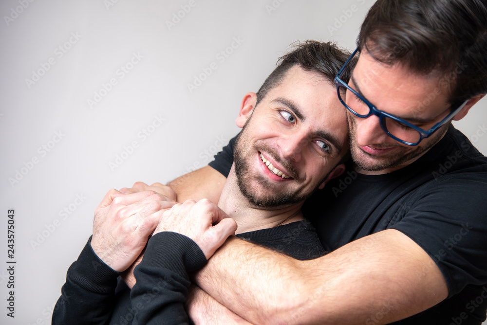 Foto Stock Sexy young gay couple in love, embracing and hugging each other  | Adobe Stock