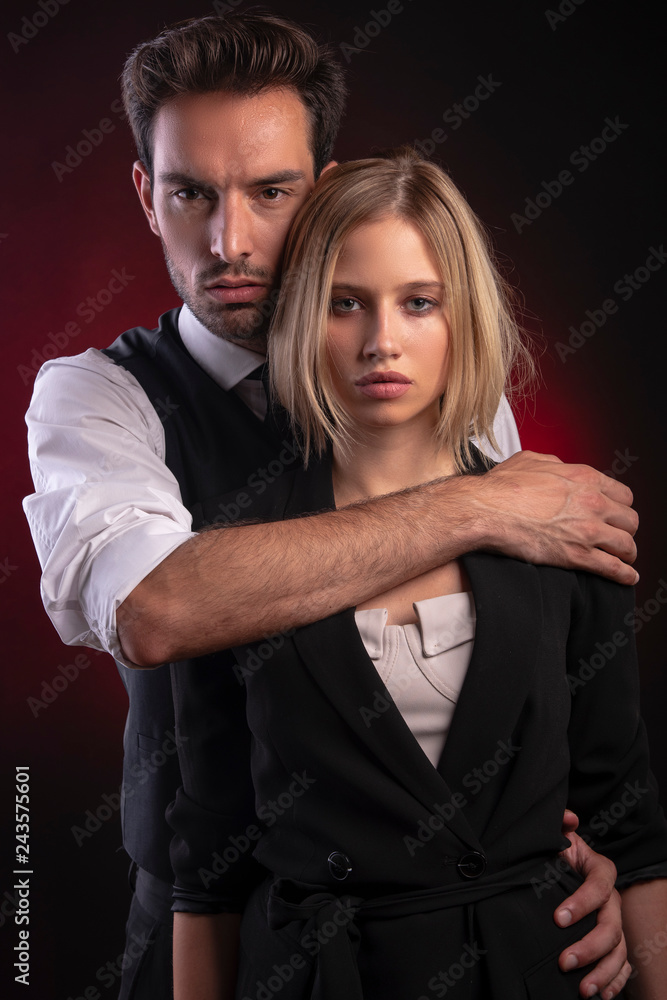 Sexy attractive young couple dressed in smart elegant clothes