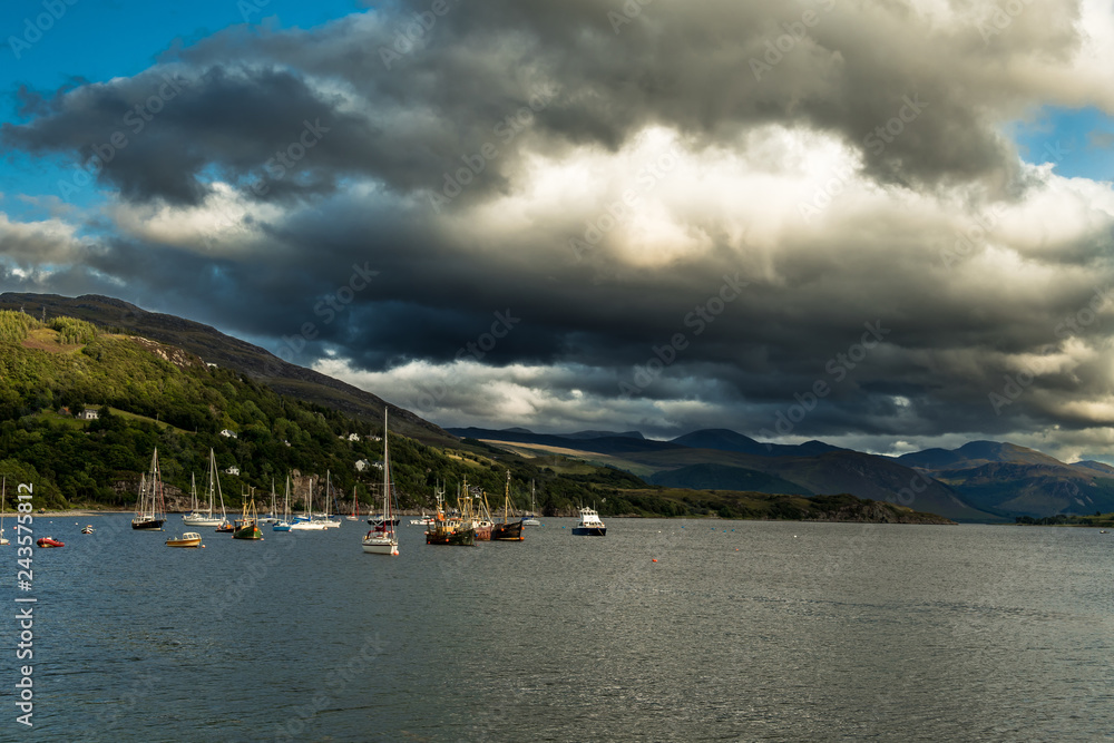 Old Weathered Fishing Boats Anchored In The Harbor Of Ullapool At Loch Broom In Scotland
