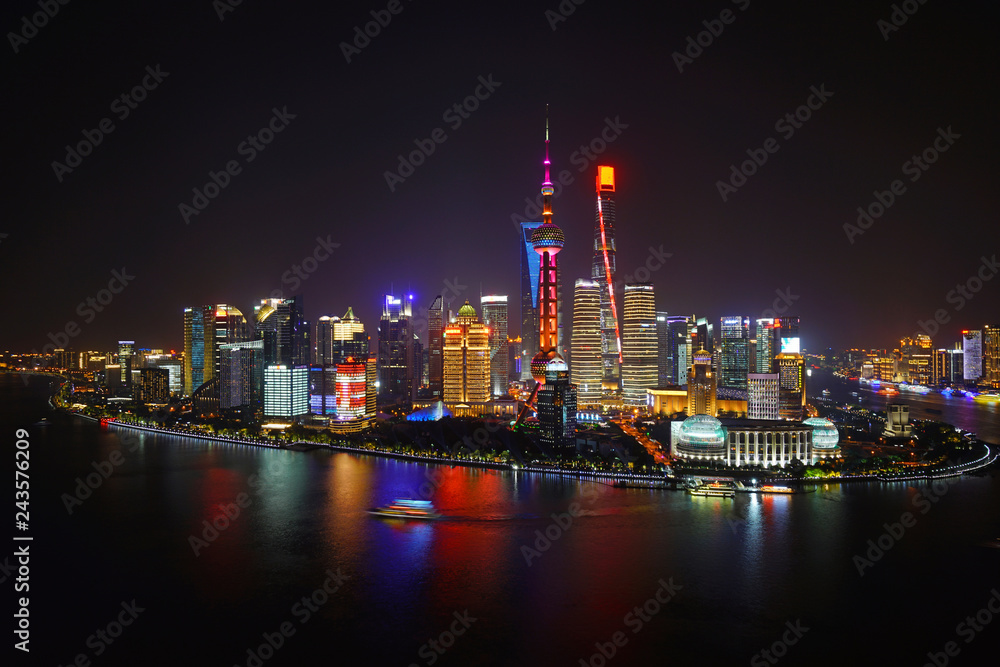 A night view of the modern Pudong skyline across the Bund in Shanghai, China A night view of the modern Pudong skyline across the Bund in Shanghai, China