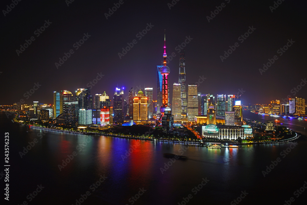A night view of the modern Pudong skyline across the Bund in Shanghai, China A night view of the modern Pudong skyline across the Bund in Shanghai, China