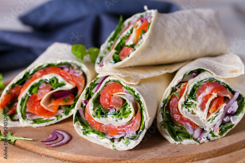 Salmon and cream cheese wraps. Wraps with salmon. Homemade tasty burrito photo