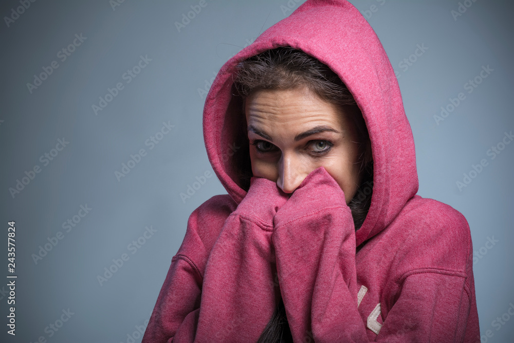 Young woman in winter clothes feeling cold, trying to warm herself up Young woman in winter clothes feeling cold, trying to warm herself up