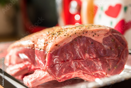 closeup view raw beef cross rib chunk on oven tray with foil photo