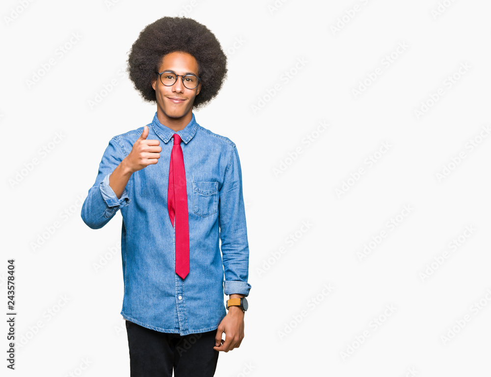 Young african american business man with afro hair wearing glasses and red tie doing happy thumbs up gesture with hand. Approving expression looking at the camera showing success. Young african american business man with afro hair wearing glasses and red tie doing happy thumbs up gesture with hand. Approving expression looking at the camera showing success.