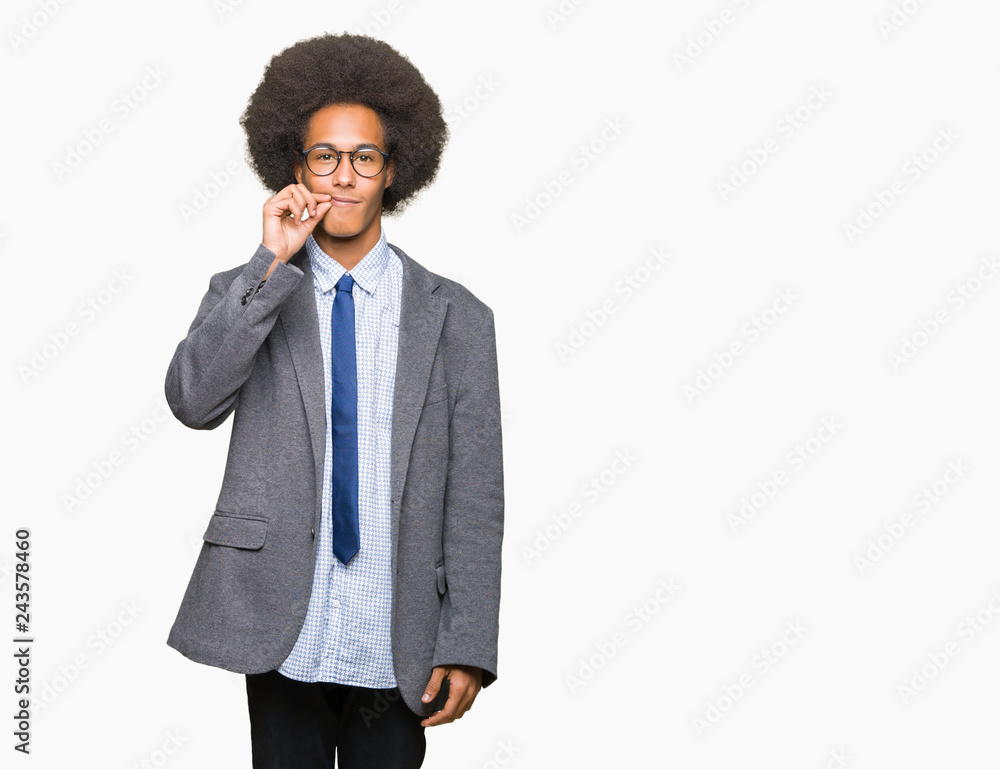 Young african american business man with afro hair wearing glasses mouth and lips shut as zip with fingers. Secret and silent, taboo talking Young african american business man with afro hair wearing glasses mouth and lips shut as zip with fingers. Secret and silent, taboo talking