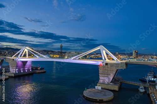  Port Vell with its bridge Porta d'Europa and the aerial tramway tower Torre Jaume I in Barcelona at night photo