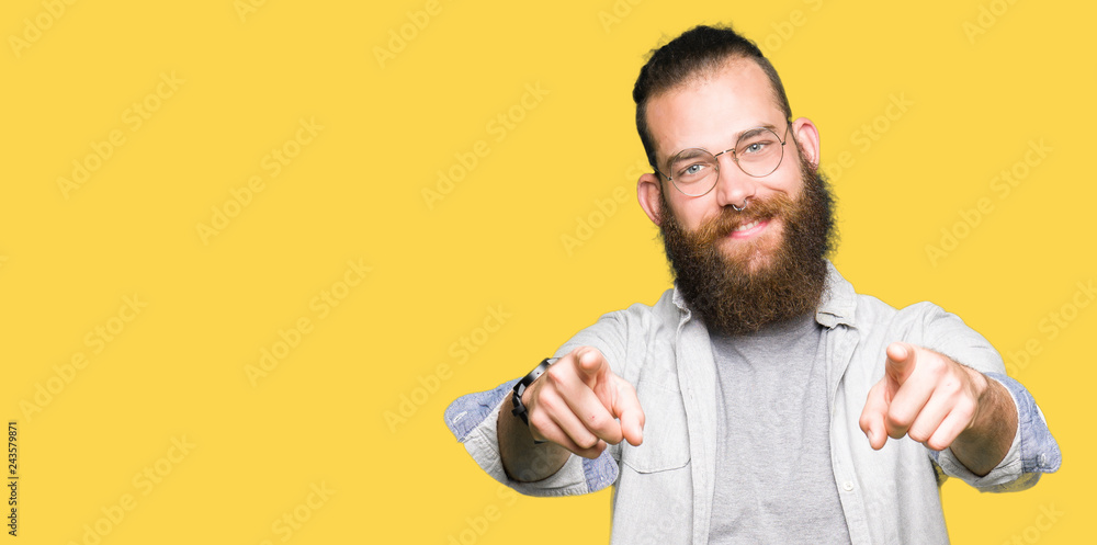 Young blond man wearing glasses Pointing to you and the camera with fingers, smiling positive and cheerful Young blond man wearing glasses Pointing to you and the camera with fingers, smiling positive and cheerful