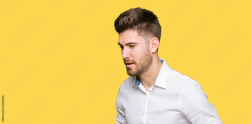 Young handsome business man with hand on stomach because nausea, painful disease feeling unwell. Ache concept. Young handsome business man with hand on stomach because nausea, painful disease feeling unwell. Ache concept.