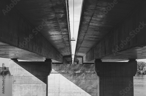 Under the bridge. Abstract concrete construction, black and white.