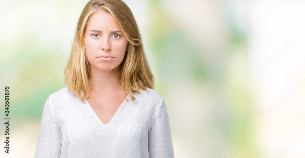 Beautiful young elegant woman over isolated background skeptic and nervous, frowning upset because of problem. Negative person. Beautiful young elegant woman over isolated background skeptic and nervous, frowning upset because of problem. Negative person.
