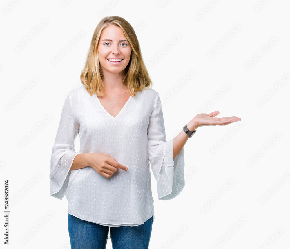 Obraz premium Beautiful young elegant woman over isolated background smiling cheerful presenting and pointing with palm of hand looking at the camera.