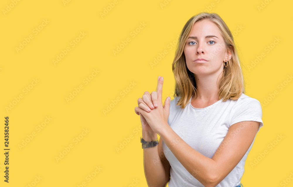 Beautiful young woman wearing casual white t-shirt over isolated background Holding symbolic gun with hand gesture, playing killing shooting weapons, angry face Beautiful young woman wearing casual white t-shirt over isolated background Holding symbolic gun with hand gesture, playing killing shooting weapons, angry face