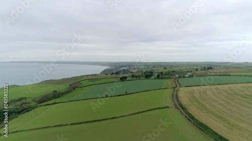 Aerial tracking over coastal farmland in the perfect English countryside. various fields for livestock and crops. photo