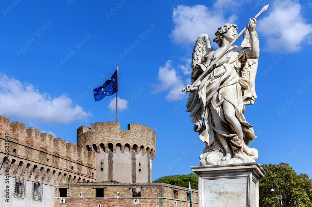 Marble statue of an angel with a spear against the background of part of the Castle of the Holy Angel and the flag of the European Union. Rome, Italy.